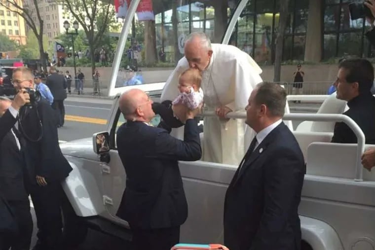Pope Francis gives little Gianna Masciantonio a kiss during his visit to Philly in September.