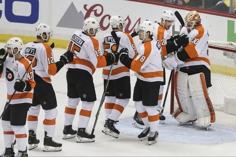 Flyers goalie Michal Neuvirth celebrates with teammates Friday after beating the Penguins 4-2 in Game 5 in Pittsburgh.