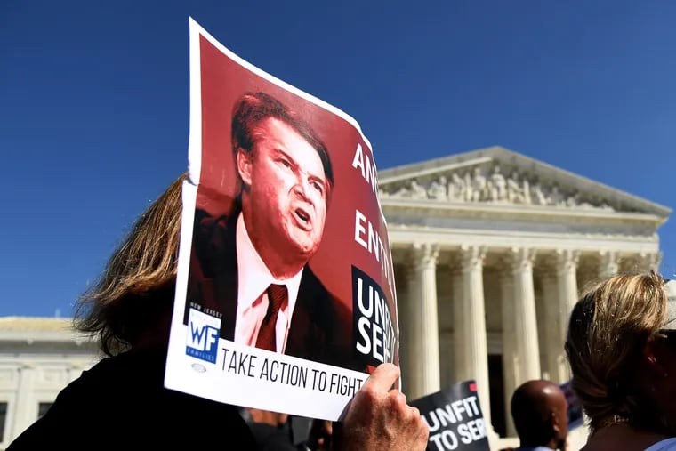 A protester holds a poster of Judge Brett Kavanaugh in front of the U.S. Supreme Court this week in Washington.