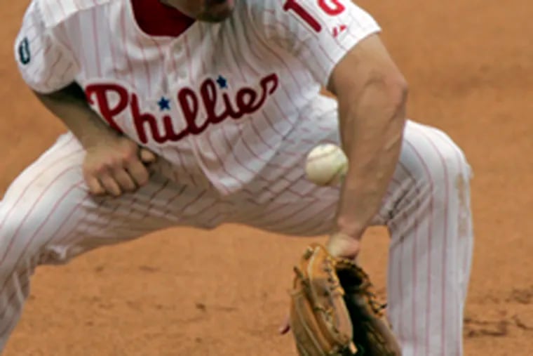 Third baseman Wes Helms cannot control a ball hit by Ryan Zimmerman in the seventh inning of the Phillies&#0039; 4-2 defeat.