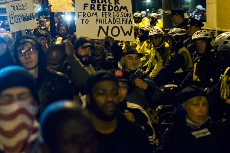 Protesters on Tuesday, Nov. 25, 2014, outside a police station in Philadelphia. (AP Photo/Matt Rourke)
