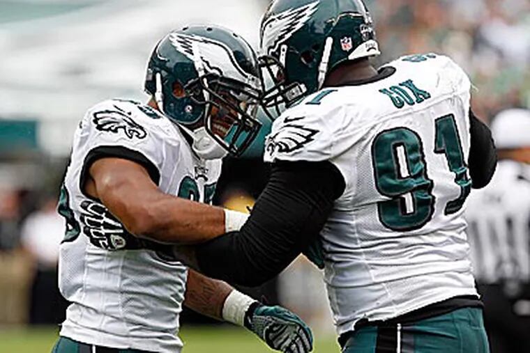 Eagles rookies Mychal Kendricks and Fletcher Cox celebrate a fourth-down stop late in the game. (Yong Kim/Staff Photographer)