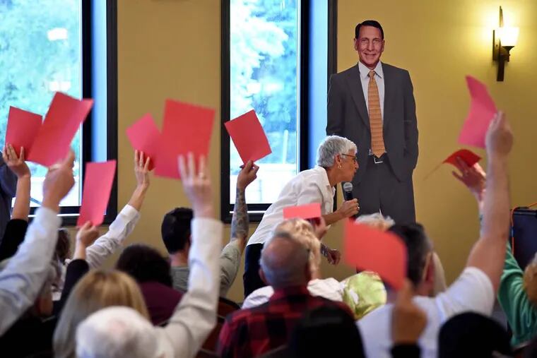 A cardboard cutout of U.S. Rep. Frank LoBiondo stands in for him at town hall for his constituents in Egg Harbor City May 31, 2017. At the microphone is Tamar Sherer, of Long Beach Township, who organized the meeting.