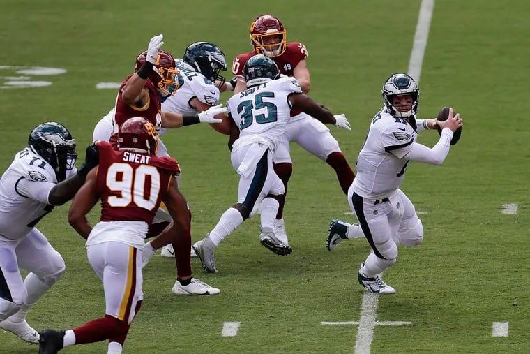 Eagles quarterback Carson Wentz scrambling against Washington on Sunday.