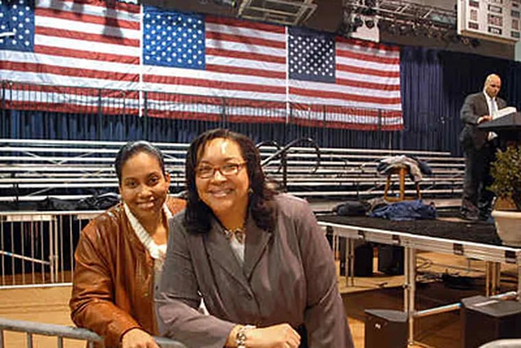 Leslie Banks (right) and her daughter, Helena, in the Arcadia University venue where Banks introduced the president. She was invited to make the introduction after e-mailing Obama about her soaring health-insurance premiums. (Tom Gralish / Staff)