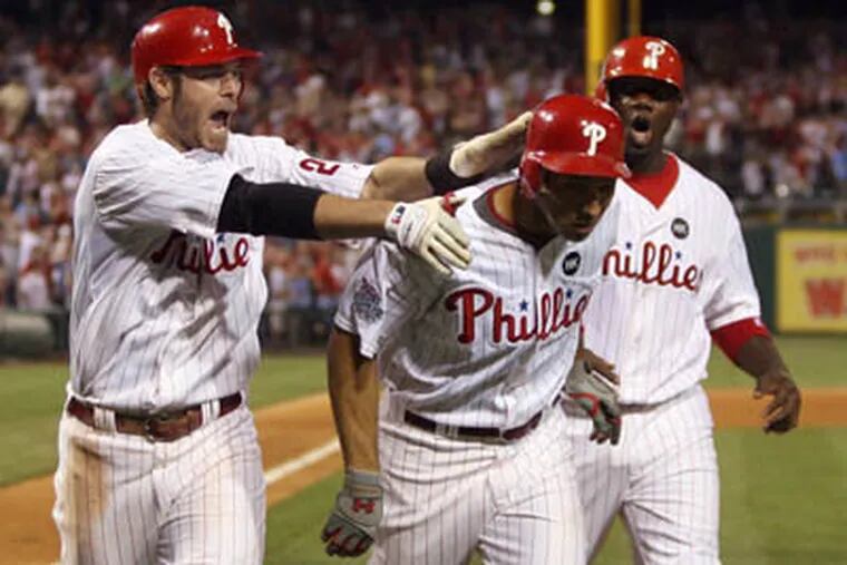 Phillies' Raul Ibanez celebrates his eighth grand slam home run with teammate Jayson Werth and Ryan Howard against the Washington Nationals on Monday, April 27, 2009.                   (Yong Kim / Staff Photographer)