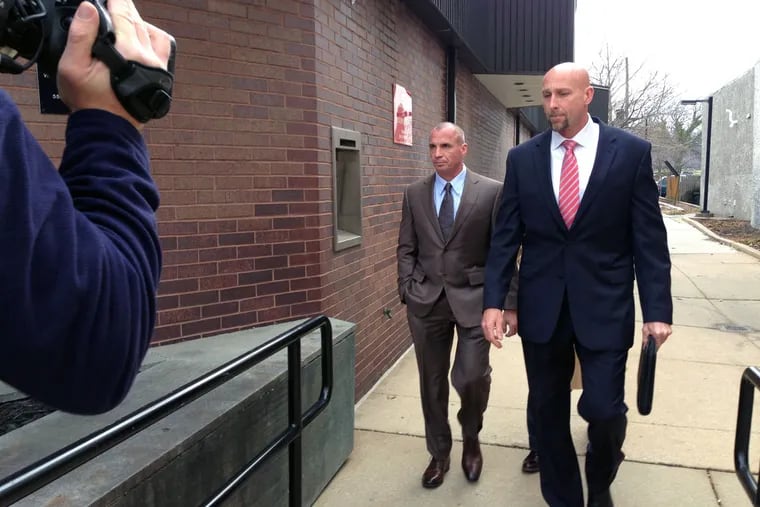 James Donato (left), former Coatesville schools athletic director, walked into district court with his lawyer in 2014 for his arraignment on theft charges.