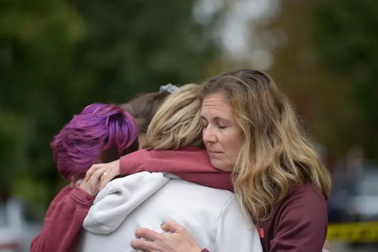 From left Cody Murphy, 17 Sabrina Weihrauch, and Amanda Godley, left, all of Pittsburgh, hug after an active shooter situation at Tree of Life Synagogue on Saturday, Oct. 27, 2018. Multiple casualties have been reported at the synagogue.