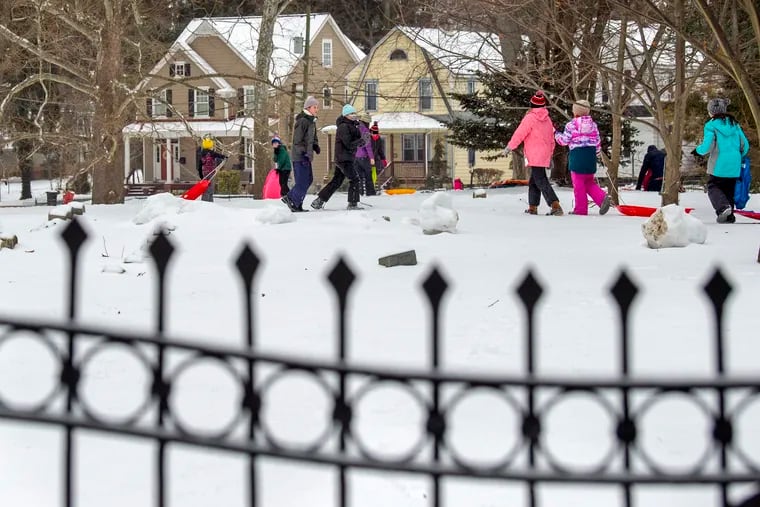 In this February 2021 file photo, sledders enjoy a snowy day inside the Haddonfield Friends Meeting Burial Grounds. Authorities are investigating the spraypainting of two swastikas discovered outside the cemetery Friday.