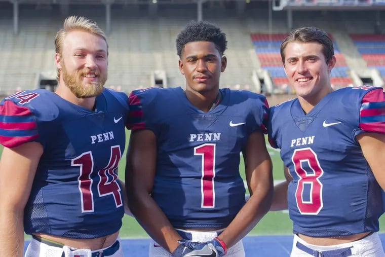 Quarterbacks (from left) Will Fischer-Colbrie, Ryan Glover, and Nick Robinson pose for photos during Penn Football Media Day at Franklin Field.