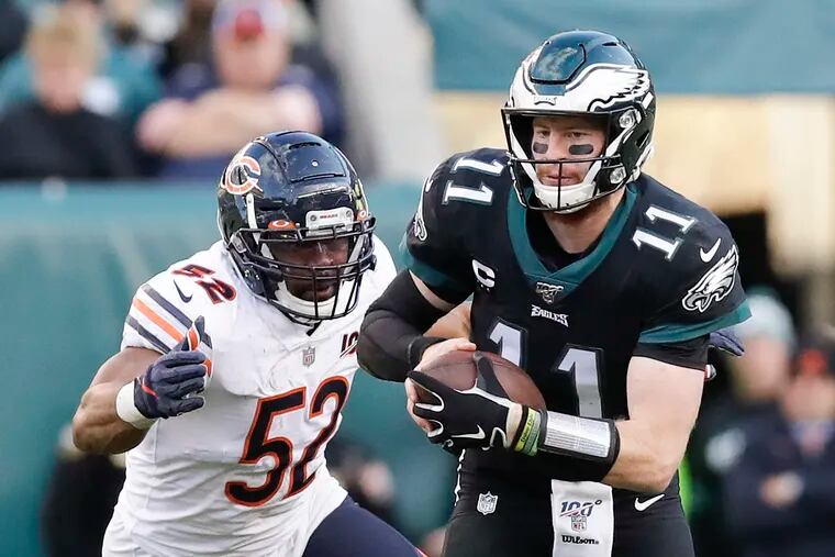 Carson Wentz (right) gets away from Bears outside linebacker Khalil Mack during the fourth-quarter on Sunday.
