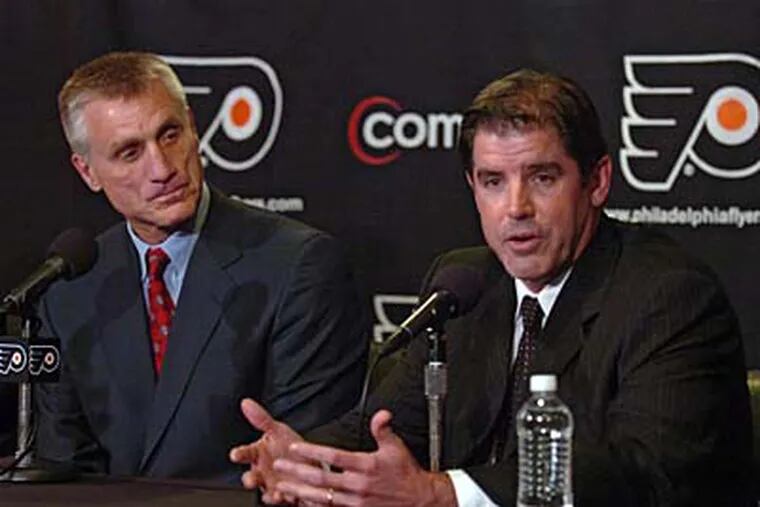 Peter Laviolette (right) answers questions after being introduced as the Flyers new head coach by GM Paul Holmgren. ( Clem Murray / Staff Photographer )