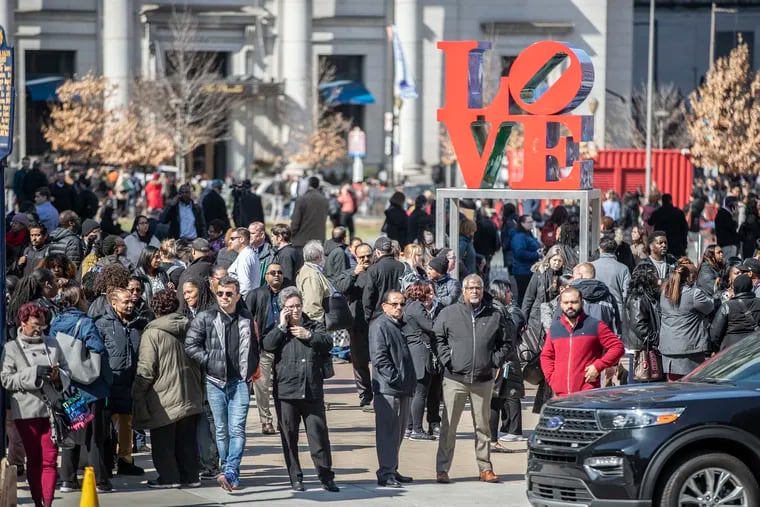 Hundreds of people stand around Love Park after being evacuated of the General Services Building at 15th Street and John F. Kennedy Boulevard after a gas-like smell was reported in Center City.