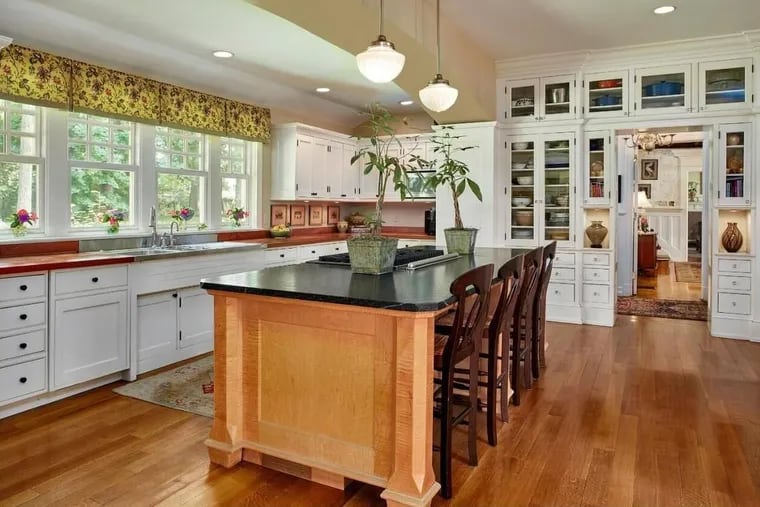 The kitchen at 156 S. Devon Ave., Devon, features custom, built-in shelving, a large center island and dual sinks.