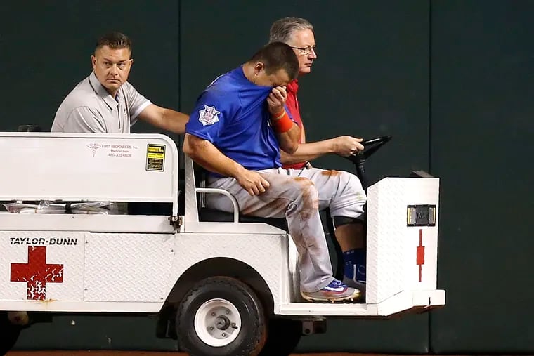 An injured Kyle Schwarber is taken off the field after injuring his left knee with the Cubs during a game against the Diamondbacks in 2016.