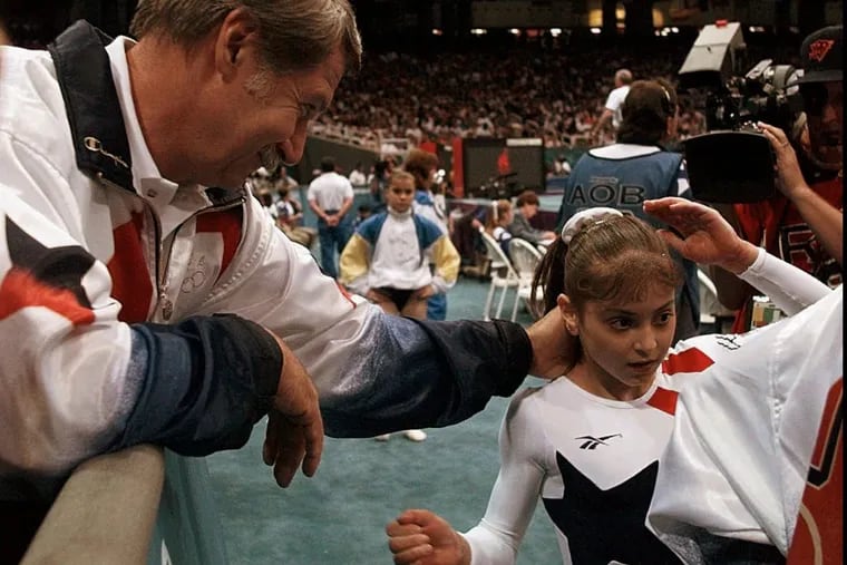 Dominique Moceanu with her coach Bela Karolyi at the Centennial Summer Olympic Games in Atlanta in 1996.