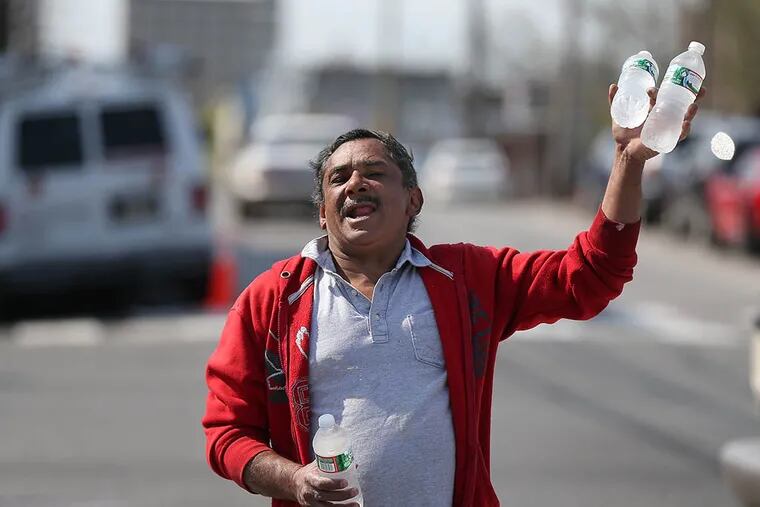 Edwin Vargas, 53, sells bottled water at 2nd Street and Lehigh Avenue in North Philadelphia.
He collects disability pay, but has to resort to selling water to afford his monthly rent, bills and food. (DAVID MAIALETTI / STAFF PHOTOGRAPHER)