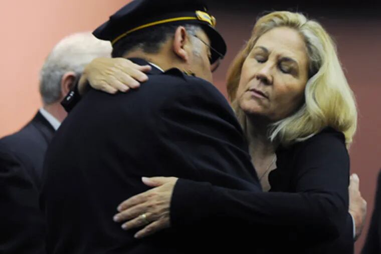 Maureen Faulkner, widow of slain Police Officer Daniel Faulkner, is hugged by Police Commissioner Charles H. Ramsey after the district attorney’s news conference, at which she spoke angrily.  (Sarah J. Glover / Staff Photographer)