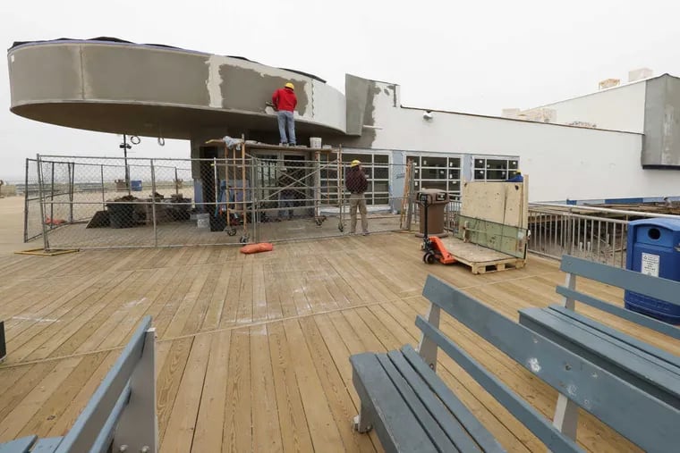 The old marquee of the Strand Theater comes back to life as workers transform the building into the newest Manco & Manco pizzeria location on the Ocean City, N.J., boardwalk.