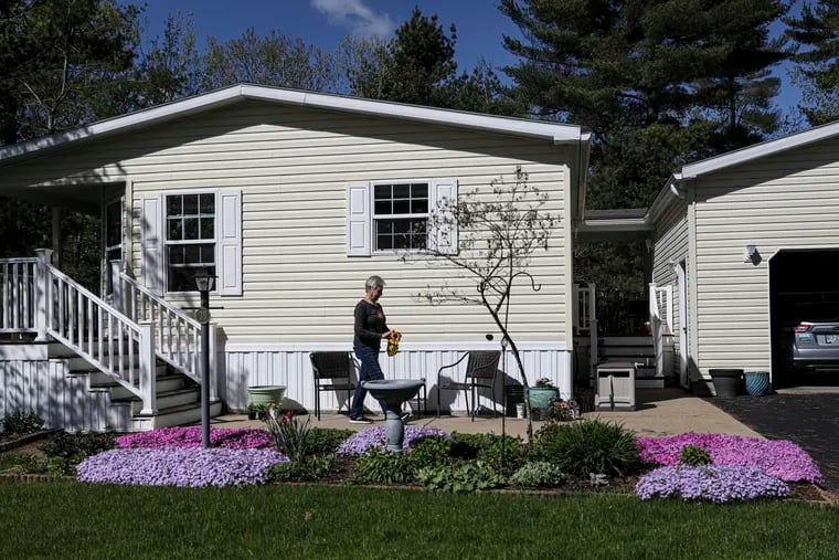 Sue Veal, 69, gardens at home in Rochester, N.H., on May 17. She moved to a mobile home park six years ago, after her husband died. She bought the mobile home for $119,000 but says lot rent has gone up from $395 a month to more than $480 since she moved in. MUST CREDIT: Photo for The Washington Post by Cheryl Senter