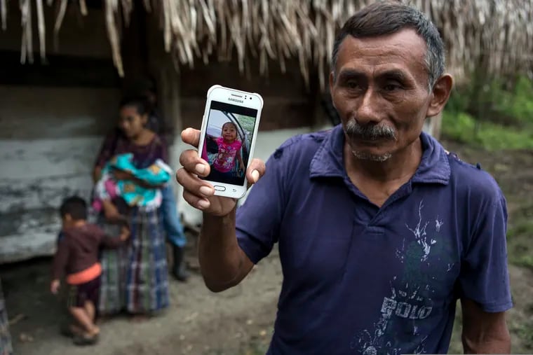 In this Dec. 15, 2018, file photo, Domingo Caal Chub, 61, holds a smartphone displaying a photo of his granddaughter, Jakelin Amei Rosmery Caal Maquin, in Raxruha, Guatemala. The 7-year-old girl died in a Texas hospital, two days after being taken into custody by border patrol agents in a remote stretch of New Mexico desert. Homeland Security's watchdog found no wrongdoing or misconduct by immigration officials in the deaths of the girl and another boy last December.