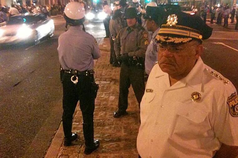 Police Commissioner Charles H. Ramsey stands on the median of Broad Street in front the Union League. South Broad Street was lined with police after the Flyers' victory. (Robert Moran / Staff)