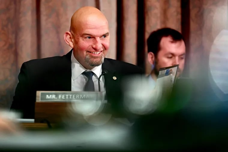 Sen. John Fetterman reacts as Sen. Katie Britt, a Republican freshman senator from Alabama, is introduced as she arrives to join the nomination hearing by the Senate Committee on Banking, Housing, and Urban Affairs at the Capitol on April 18, 2023.