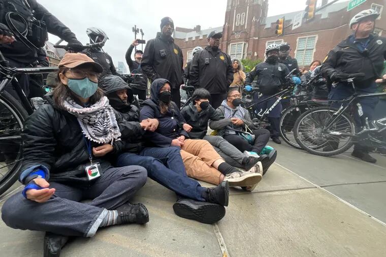 Protesters lock arms on Penn campus as police clear the Pro-Palestinian encampment at University of Pennsylvania.