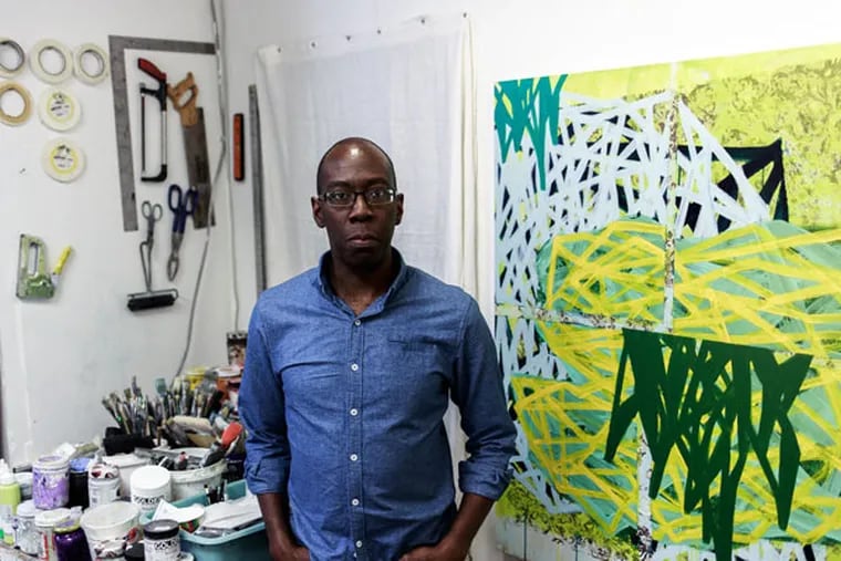 Tim McFarlane poses in his studio space in Philadelphia on Oct. 3, 2015. McFarlane says he moved to 1241 Carpenter Studios after being displaced by the surging rent in Old City. (ED NEWTON/For The Inquirer)