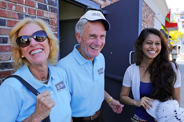 Dick and Sue LaMaina, 72 and 69, owners of the third generation Maytag commercial laundry equipment distribution company, Cherry Hill-based Equipment Marketers, talk with Alpa Patel (right) the wife of one of the owner partners of a new Maytag laundromat during the grand opening in Atlantic City August 27, 2014. ( TOM GRALISH / Staff Photographer )