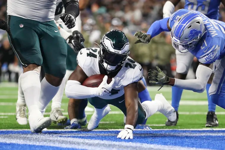 Eagles running back Jordan Howard scores a second quarter touchdown past Detroit Lions free safety Tracy Walker III on Sunday, October 31, 2021 in Detroit.