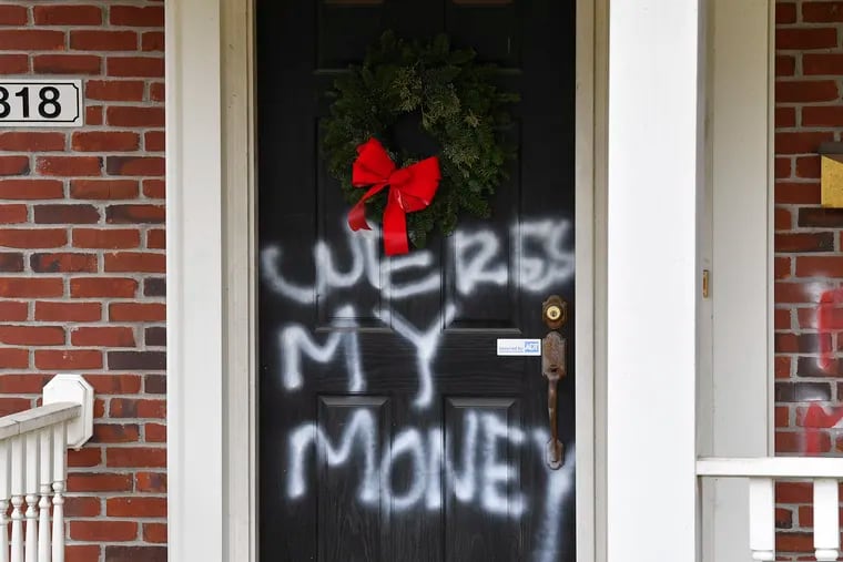 Graffiti reading, "Where's my money" is seen on a door of the home of Senate Majority Leader Mitch McConnell, R-Ky., in Louisville, Ky., on Saturday.