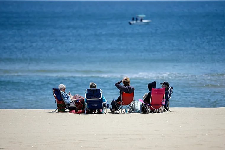 An Assembly committee advanced legislation Thursday that would make New Jersey the first state to ban smoking in all public parks and beaches. Here, people are bundled again the wind as they relax on a Jersey beach on Sunday, May 26, 2013. (AP Photo/Mel Evans/File)