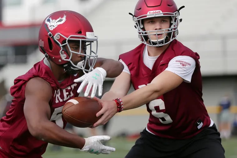 St. Joseph's Prep quarterback Kyle McCord (right) hands the ball off to running back Kolbe Burrell during a recent practice.