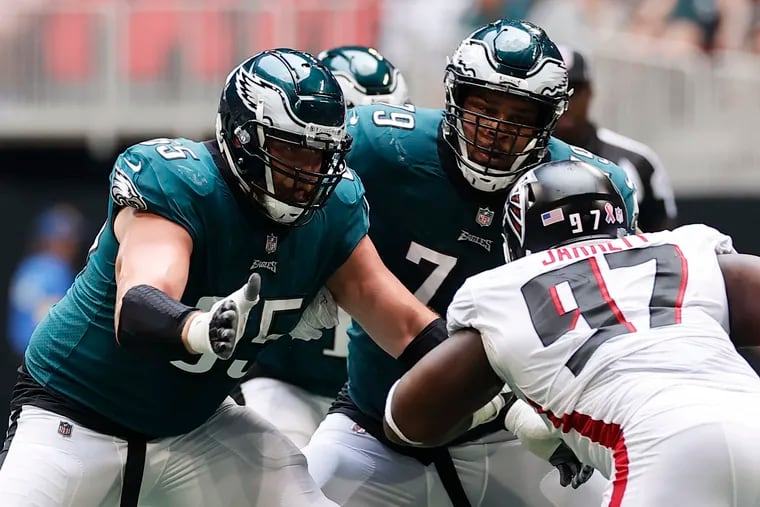 Lane Johnson (left) and Brandon Brooks blocking Atlanta Falcons defensive tackle Grady Jarrett on Sunday. Their good health is the No. 1 reason fans should believe in the 2021 Eagles.