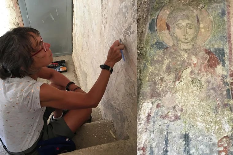 Gigi Simeone works on a wall during the frescoes restoration workshop; her favorite duty was working in a cave church scraping calcification from a 12th-century depiction of the Virgin Mary.