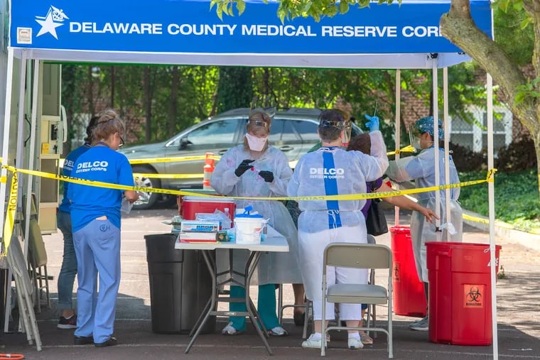 Volunteers provide coronavirus testing for any Delaware County resident over the age 18, during a walk in at the Parking Lot Adjacent to Providence Rehabilitation & Healthcare Center on Mercy Fitzgerald Campus in Delaware County during the summer.