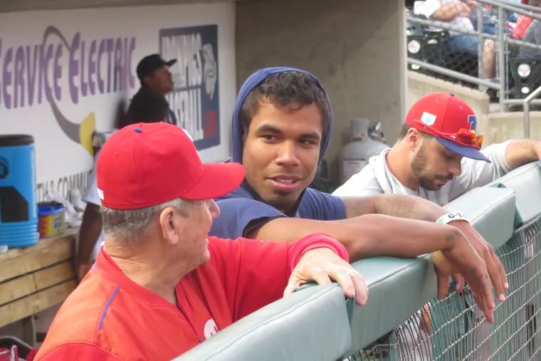 Nick Williams talking in the dugout with Phillies senior advisor to the GM Larry Bowa.