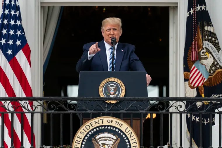 President Donald Trump speaks from the Blue Room Balcony of the White House to a crowd of supporters on Saturday.