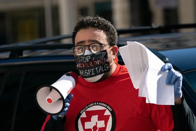 Dr. Karim Nathan, from Put people First Pennsylvania, protests to demand the re-opening of Hahnemann to save the lives of COVID-19 patients, April 01, 2020, in Philadelphia, outside the former Hahnemann Hospital building.