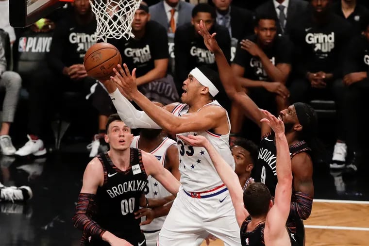 Sixers forward Tobias Harris drives to the basket past Brooklyn Nets forward DeMarre Carroll during the third-quarter in game three of the Eastern Conference playoffs on Thursday, April 18, 2019 in Brooklyn.  Harris made the basket and got fouled on the play.