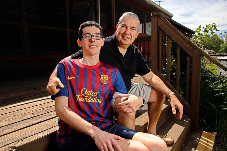 Jack Cavanaugh Jr. and Sr. on their back deck: With his dad’s help, young Jack is on the mend.