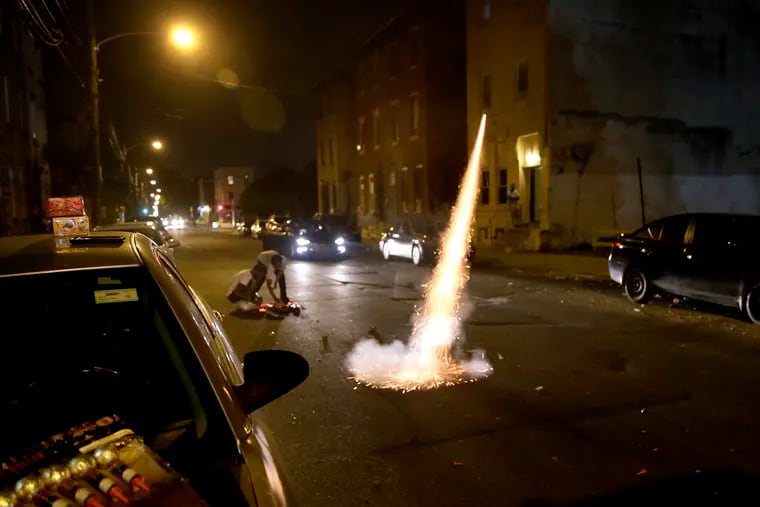 Fireworks shoot into the sky from N. 22nd Street, near W. Norris Street, in North Philadelphia last week.