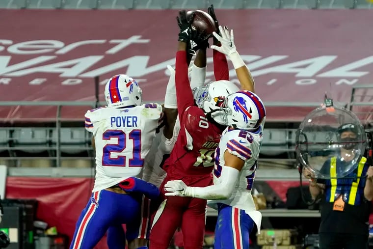 Cardinals wide receiver DeAndre Hopkins (10) pulls in the game-winning touchdown over Buffalo's Jordan Poyer (21) and Micah Hyde (23). The desperation heave from Arizona quarterback Kyler Murray came with two seconds left and lifted the Cardinals to an improbable 32-30 victory.