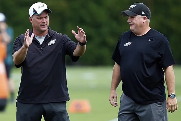 Eagles defensive coordinator Bill Davis (left) and head coach Chip Kelly (right). (Matt Rourke/AP)