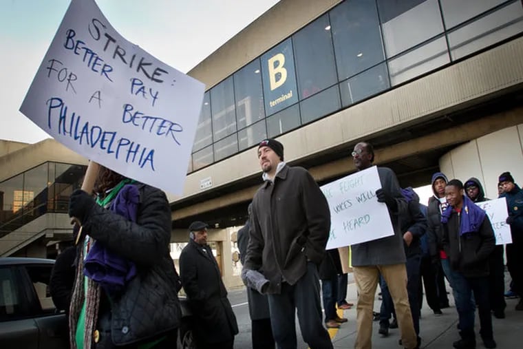 Workers with PrimeFlight at Philadelphia International Airport stage a protest outside terminal on Thursday, November 20, 2014. ( ALEJANDRO A. ALVAREZ / STAFF PHOTOGRAPHER )