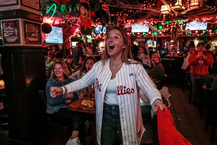 Bella Tierce watches as the Phillies' Kyle Schwarber homers in the 6th inning against the Padres at McGillin's Olde Ale House on Tuesday.