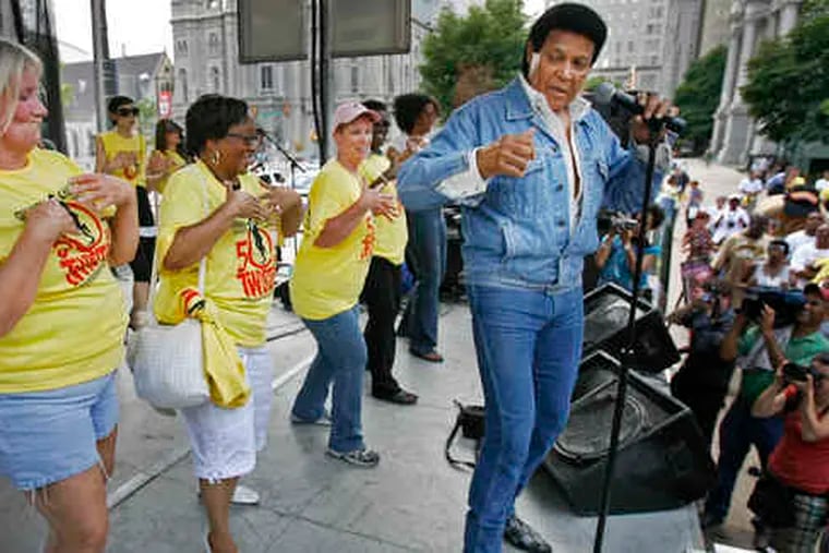 Celebrating the Twist's 50th, dancers join Chubby Checker onstage. &quot;When I was young, we twisted the night away,&quot; a fan said.