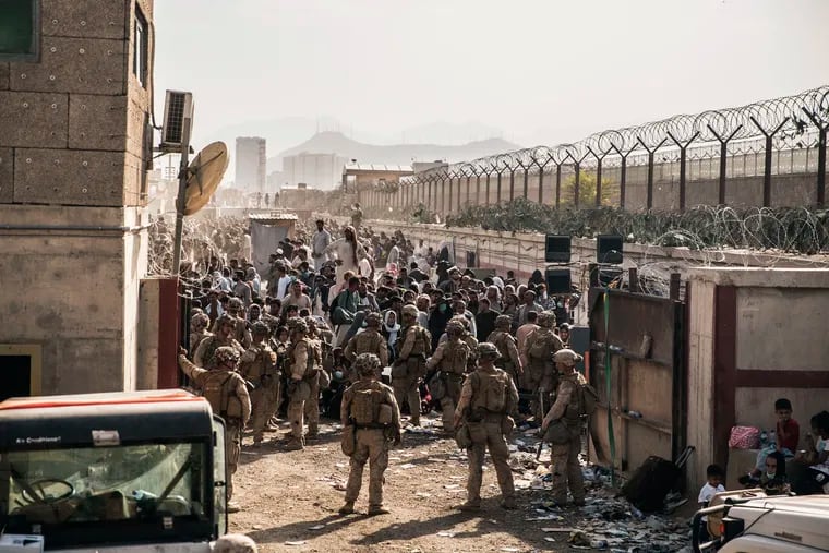 In this Aug. 21, 2021, photo provided by the U.S. Marines, U.S. Marines provide assistance at a control checkpoint during an evacuation at Hamid Karzai International Airport in Kabul, Afghanistan. Many of those who eventually made it to the United States endured harrowing escapes in which they could have been injured or killed. Many who made it to the US.S. say their faith has been a comfort. (Staff Sgt. Victor Mancilla/U.S. Marine Corps via AP, File)