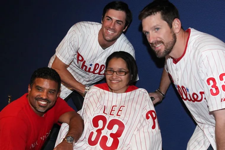 Jose Claudio poses with his wife Jovita, a person with ALS, and Phillies
Pitchers Cole Hamels (left) and Cliff Lee at the 24th annual Phillies
Phestival Fund raising party to help strike out ALS at Citizens Bank Park, Thursday, May 16, 2013. (Steven M. Falk/Staff Photographer)